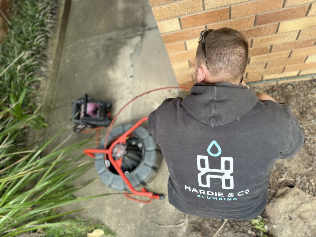 Hardie and Co plumber working on a blocked drain