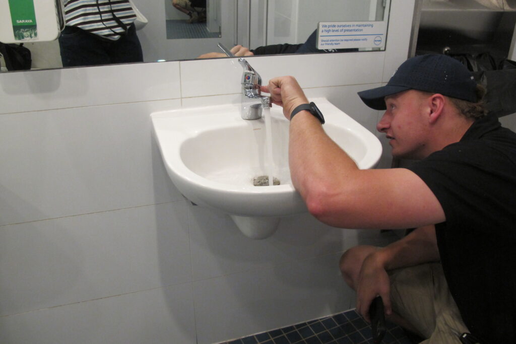 Hardie and Co plumber fixing a tap in a home